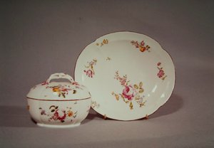 Mennecy Sugar bowl with its quatrefoil shaped charger, decorated with a multicoloured flower design by French School